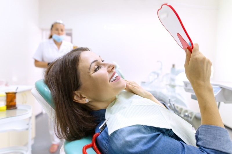 Patient smiling after getting dental implants